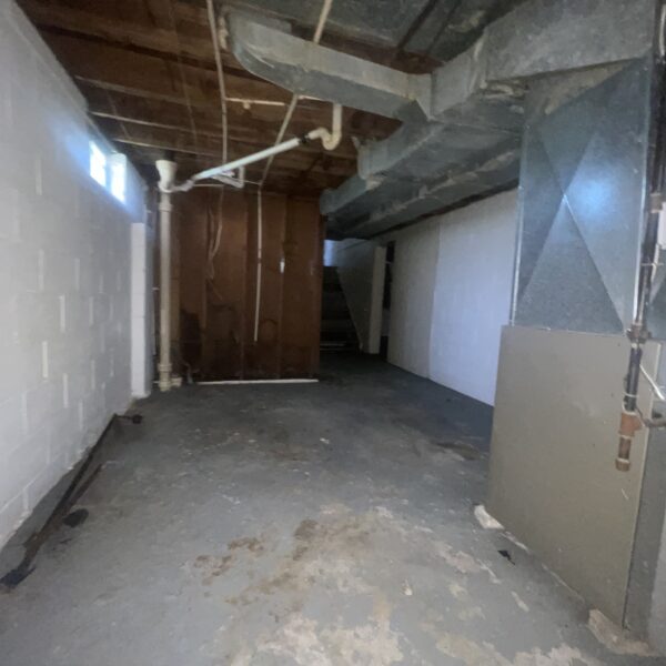 an empty basement with concrete floor