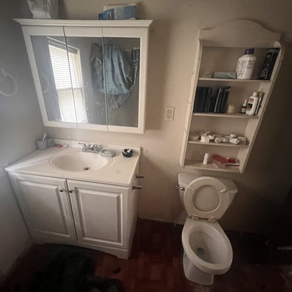 a commode and sink in the bathroom