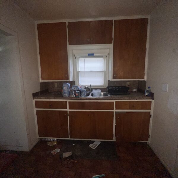 view of a small kitchen area with cabinets