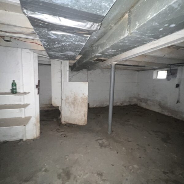 an empty basement with storage shelves