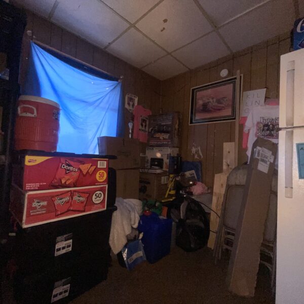 a storage room with a refrigerator