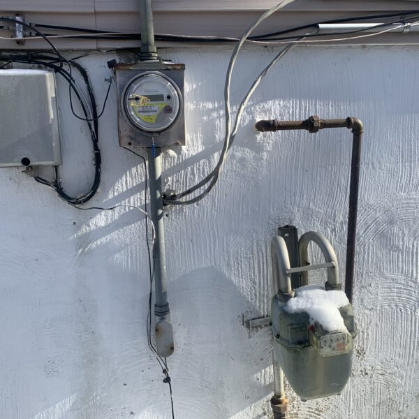 view of an electric meter on the wall outside