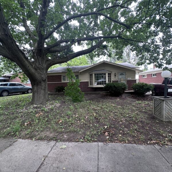 A house with a tree in front of it.