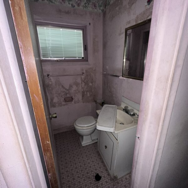 A bathroom with a sink and toilet in it.